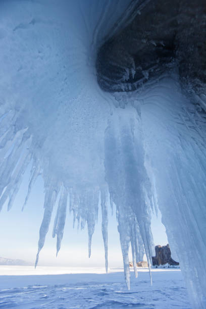 Icicles in cave. Lake Baikal, Oltrek island. Winter landscape