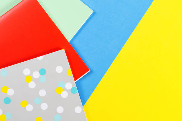 istock Colorful notebooks on blue and yellow background 905461434