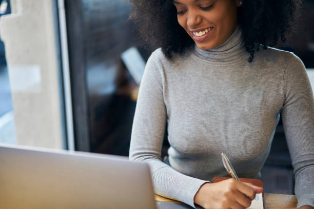 istock Cheerful female freelancer with curly hair working on new startup project making internet researchers analyzing data using laptop computer and wireless connection to 4G internet in cafe wifi zone 905464480