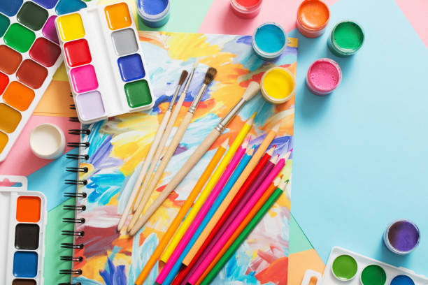 istock paints, pencils and brushes on paper 905468254