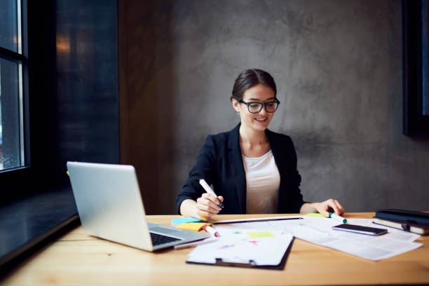 istock Creative female web designer working on outlay for project planning of apartment getting started to make online model to show clients using laptop computer connected to free wireless internet 905471894