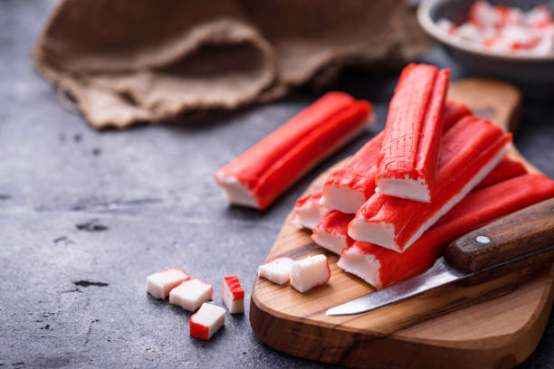 istock Crab sticks surimi and knife 905473184