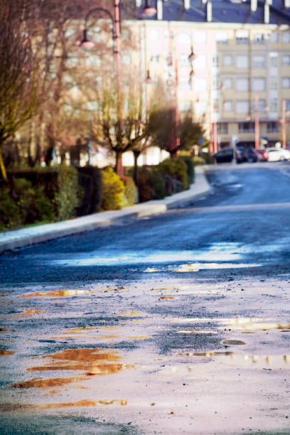 istock Road in bad condition, rainy weather, potholes. 905473436