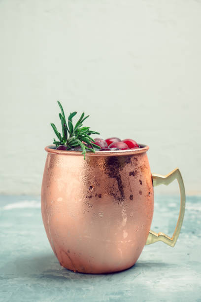 istock Cold christmas Moscow Mule cocktail in copper mug on the rustic background 905474254