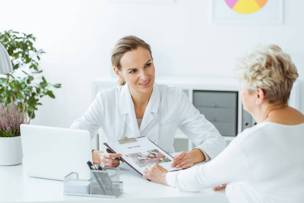 istock Smiling dietitian holding diet plan 905476792