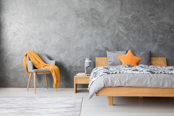 istock Grey bedroom with chair 905476800