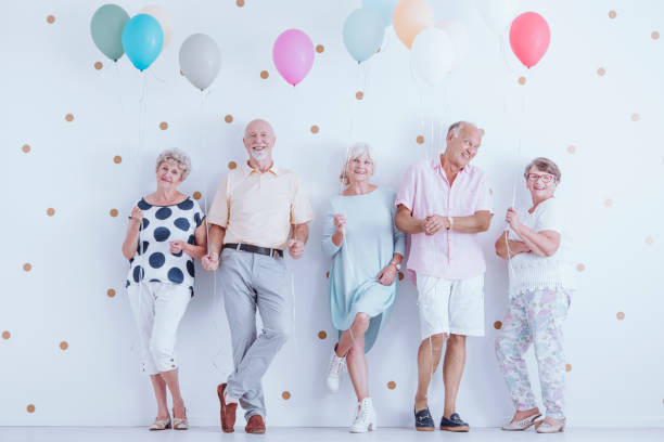 istock Happy pensioners holding balloons 905476882