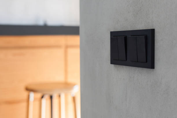 istock New black switch and socket on the grey wall in the kitchen background 905480254