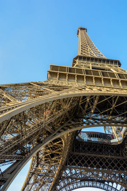 istock Dynamic view from below of the Eiffel Tower against blue sky 905480718