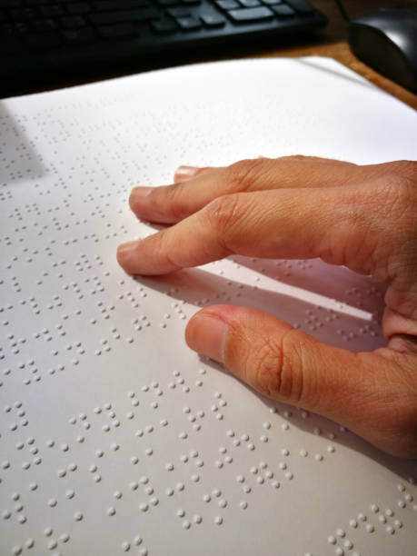 istock Blind Woman Read Book Written In Braille. Close Up Finger Touch To Braille Code 905481146