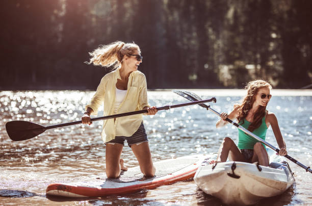 istock Group of Friends Paddle Boarding (sup) on Lake 905487078