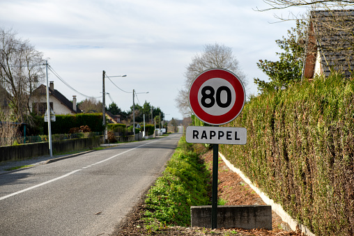 30 kilometers hour speed limit sign painted on asphalting road