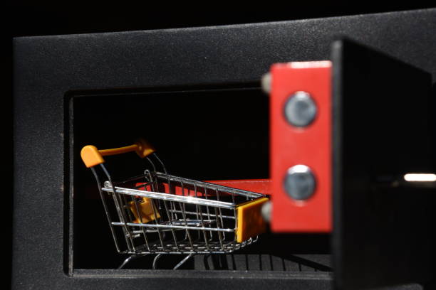 istock Shopping cart in  safe box 905489616
