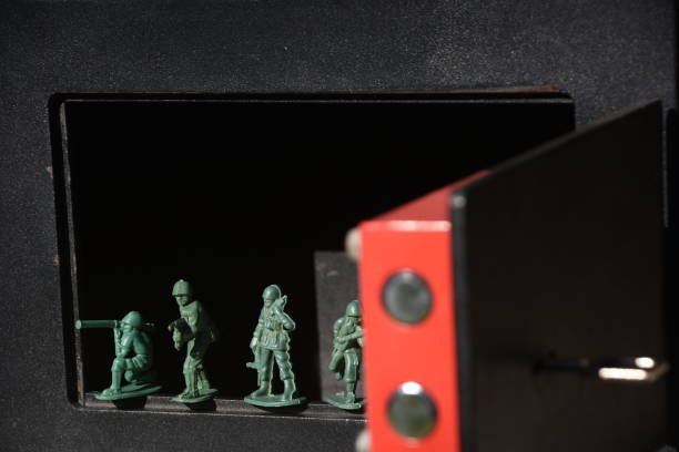istock Toy Soldiers in  safe box 905497888