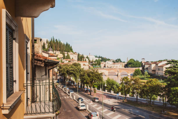 verona, italien. landschaft mit fluss etsch und ponte di pietra am sommertag mit blauem himmel. panorama. alte europäische italienische stadt, blick vom balkon - verona italy bridge ponte pietra italy stock-fotos und bilder