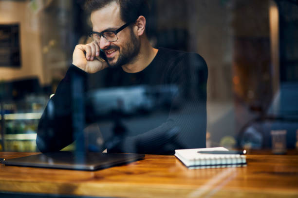 istock Cheerful male traveller blogger having phone conversation using free wireless internet connection talking about adventures being on trip preparing articles and multimedia files to share with followers 905504532