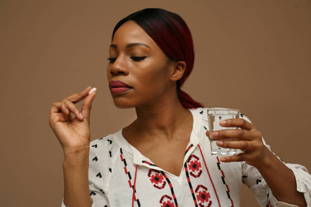 istock African woman taking pills. Close up. 905505442