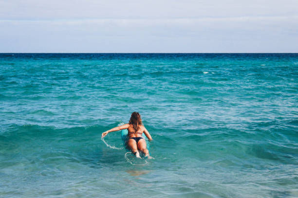 istock Surf girl in the ocean 905507674