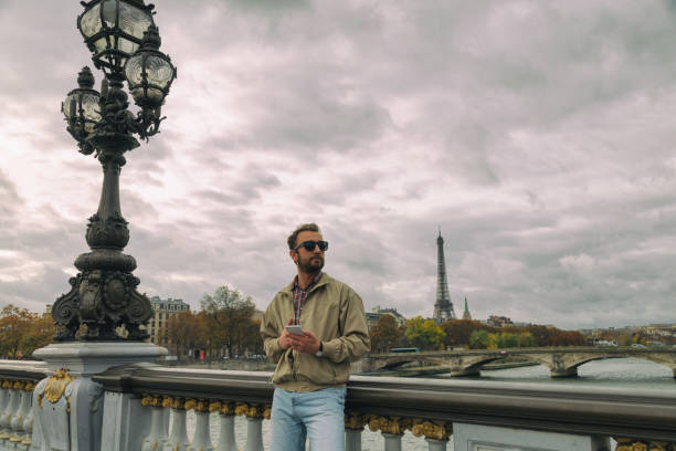 istock Modern man using smart phone in the European city. 905507964