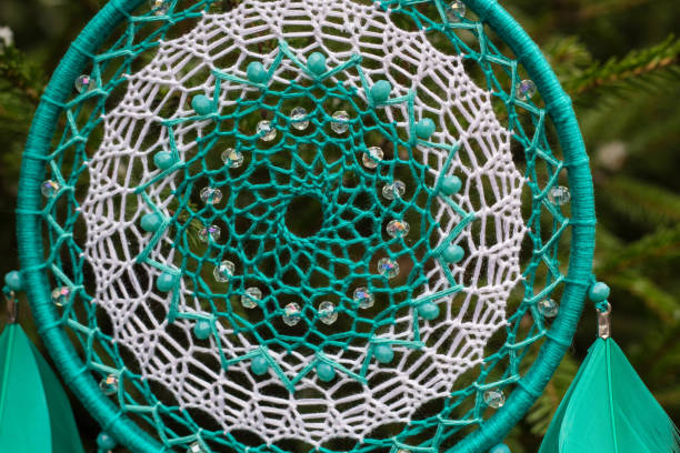 istock Handmade dream catcher with feathers threads and beads rope hanging 905508384