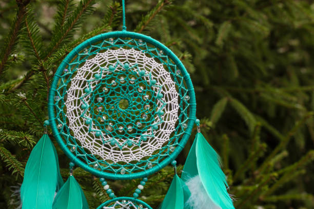 istock Handmade dream catcher with feathers threads and beads rope hanging 905508392