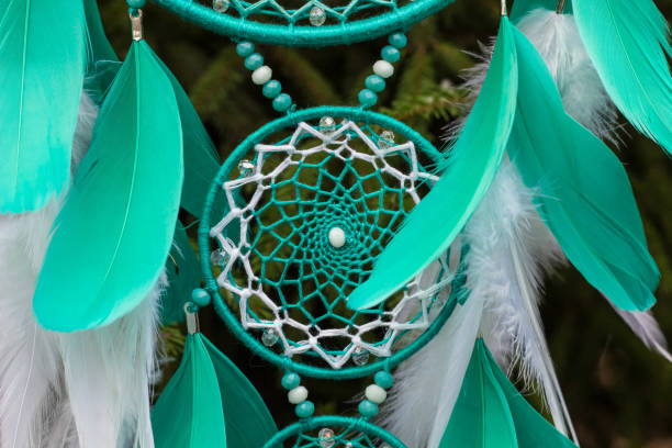 istock Handmade dream catcher with feathers threads and beads rope hanging 905508400