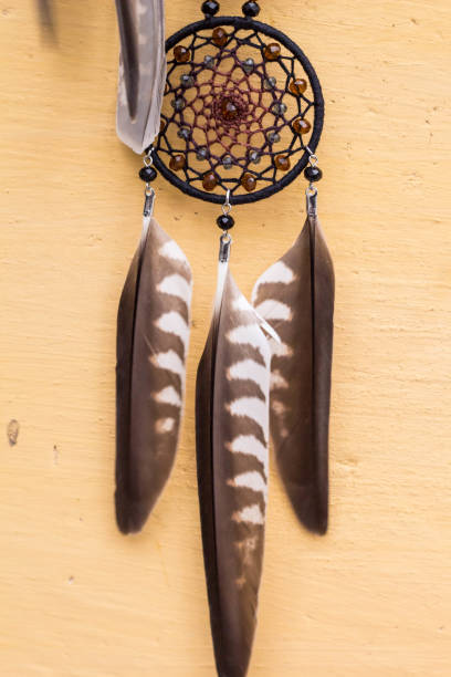 istock Handmade dream catcher with feathers threads and beads rope hanging 905508448