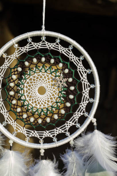 istock Handmade dream catcher with feathers threads and beads rope hanging 905508494