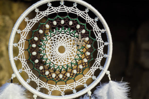 istock Handmade dream catcher with feathers threads and beads rope hanging 905508512