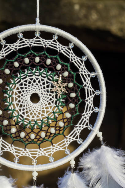 istock Handmade dream catcher with feathers threads and beads rope hanging 905508558