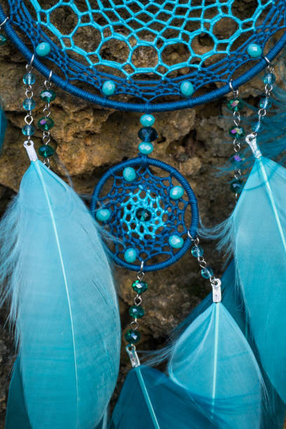 istock Handmade dream catcher with feathers threads and beads rope hanging 905508596