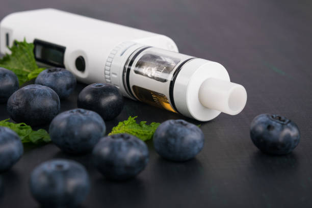 istock blueberry with mint and an electronic cigarette on a dark background 905514356
