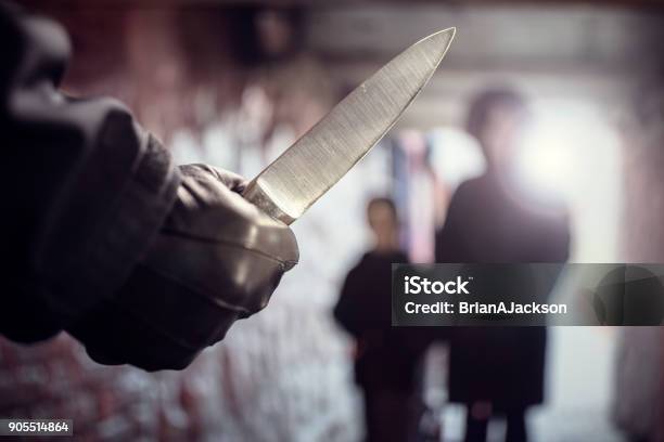 Criminal With Knife Weapon Threatening Woman In Underpass Crime Stock Photo - Download Image Now