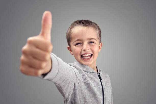 boy with thumbs up agreeing - congratulating winning agreement thumbs up imagens e fotografias de stock