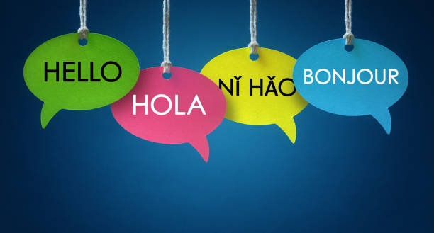 Foreign language communication speech bubbles Foreign language colorful communication speech bubbles hanging from a cord over blue background hello single word photos stock pictures, royalty-free photos & images