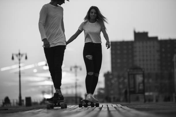 istock Couple riding longboards 905515694