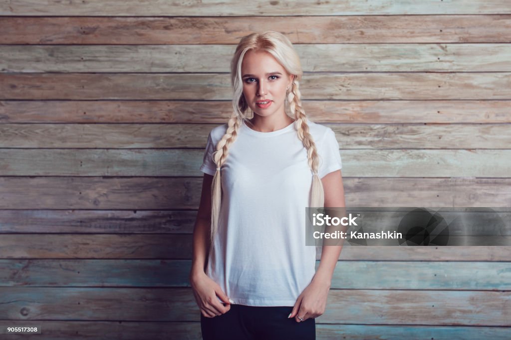 Beautiful girl with two braids in a white T-shirt. Mock-up. Pigtails Stock Photo