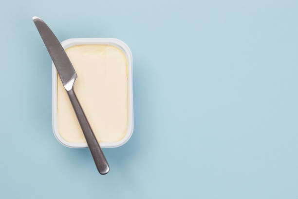 Butter Box of butter isolated on blue background margarine stock pictures, royalty-free photos & images