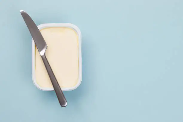 Box of butter isolated on blue background