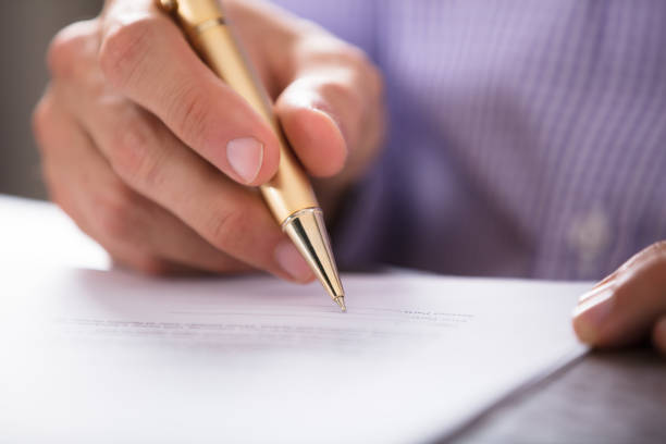 istock Businessperson's Hand Signing Document With Pen 905523980