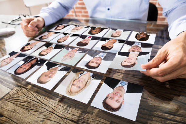 Businessman Making Candidate Selection For Job Close-up Of A Businessman Making Candidate Selection Over The Desk At Workplace candidate photos stock pictures, royalty-free photos & images