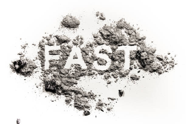 istock Fast word written in ash, dust or sand 905530134