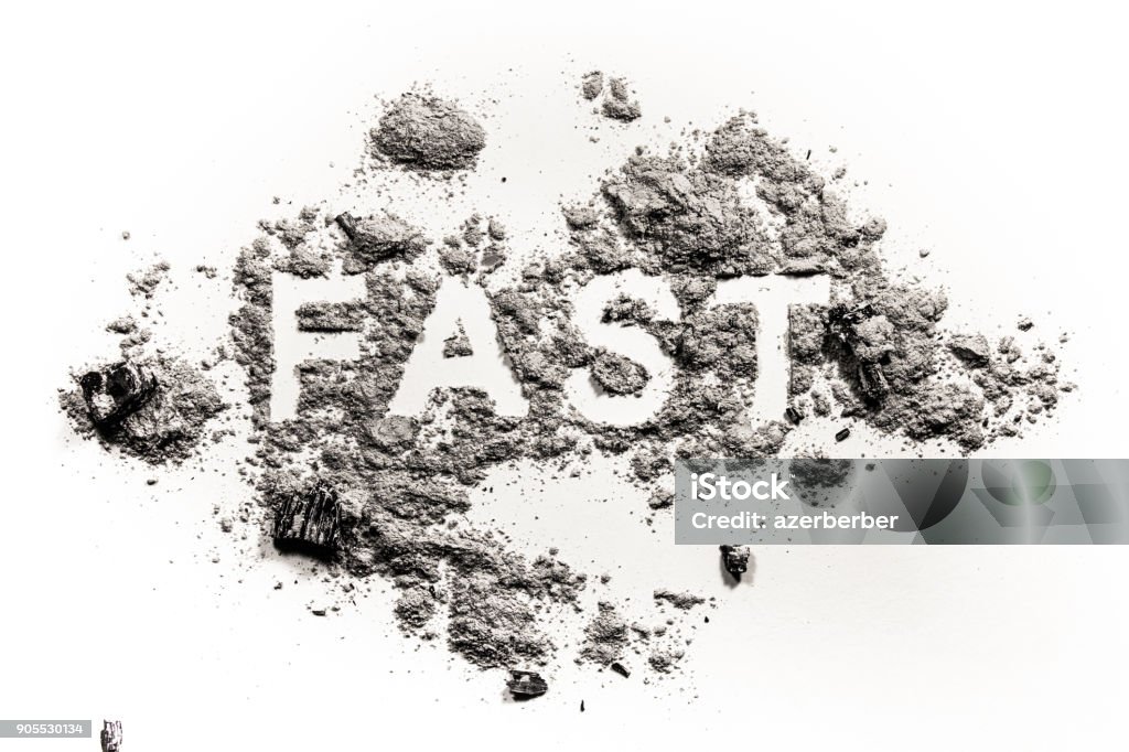 Fast word written in ash, dust or sand Fast word written in ash, dust or sand as fasting for christian holiday Ash Wednesday, Good Friday, Christmas Eve, Jesus in desert time in lent period Ash Stock Photo