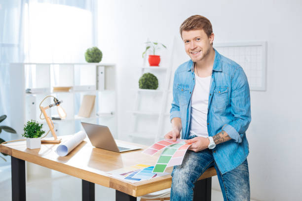istock Handsome man holding color palettes and smiling 905530846