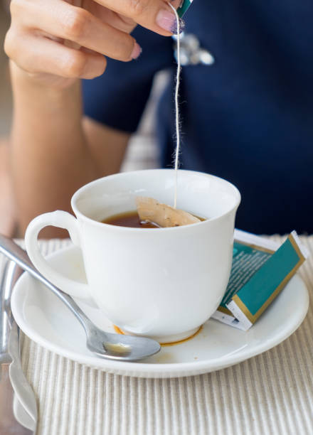 istock Hand women dipped in tea cup 905531270