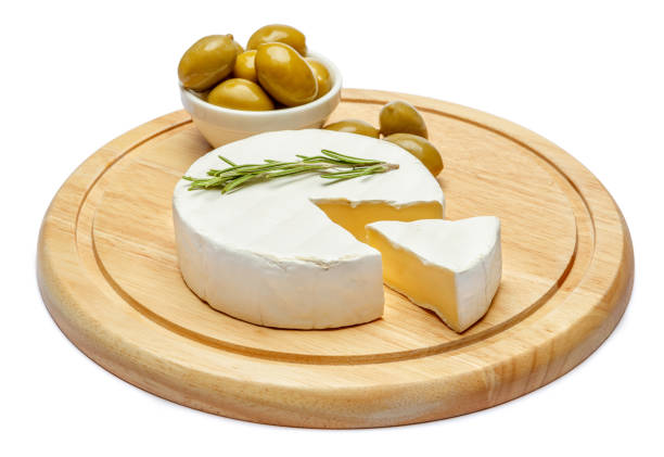istock Round brie or camambert cheese on cutting board white background 905534240