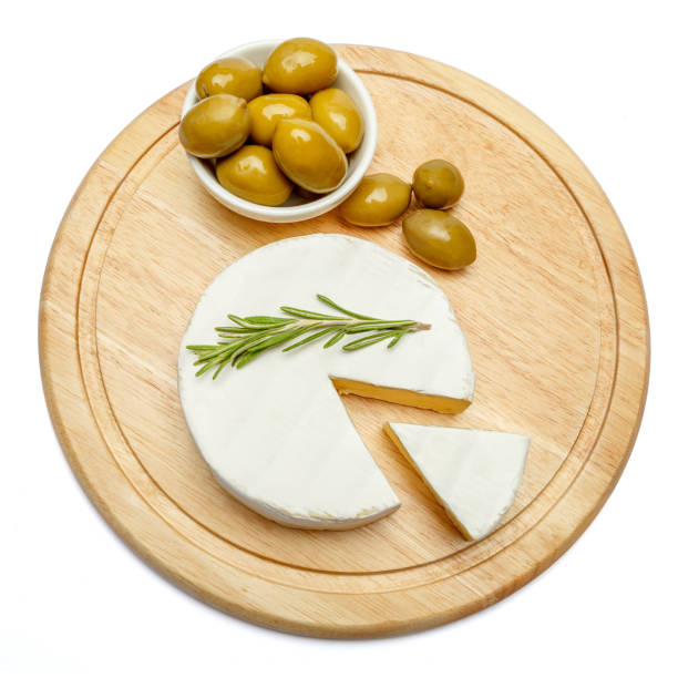 istock Round brie or camambert cheese on cutting board white background 905534288