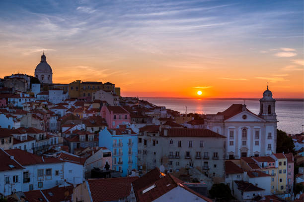 View of the Alfama neighbourhood from the Portas do Sol viewpoint at sunrise in Lisbon, Portugal View of the Alfama neighbourhood from the Portas do Sol viewpoint at sunrise in Lisbon, Portugal; Concept for travel in Portugal, visit Portugal and most beutiful places in Portugal national pantheon lisbon stock pictures, royalty-free photos & images