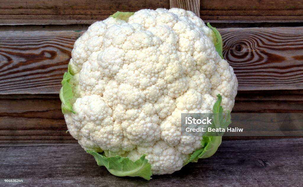 Fresh isolated vegetables concept. white cauliflower on a wooden background. Agriculture Stock Photo