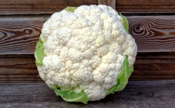 Fresh isolated vegetables concept. white cauliflower on a wooden background. kohlmarkt street photos stock pictures, royalty-free photos & images